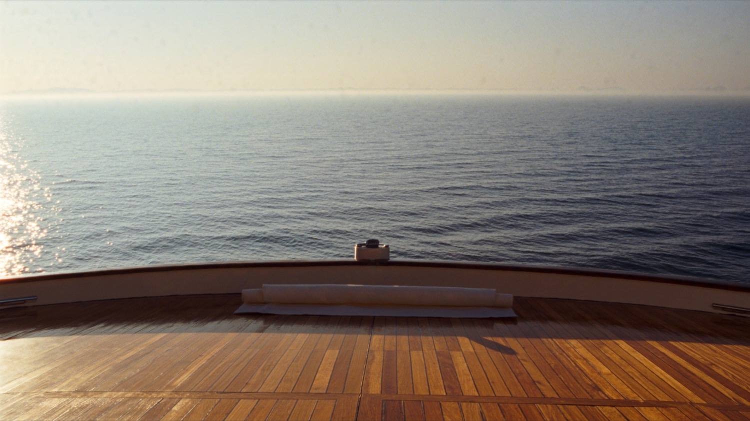 Bare feet on a mat facing the ocean horizon