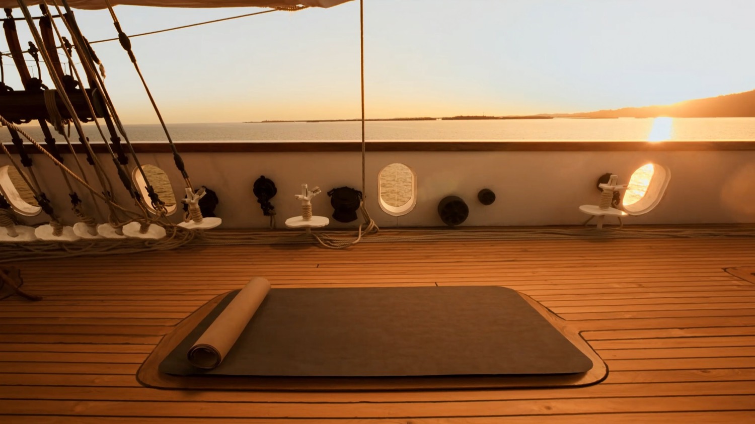 A pilates mat laid on a yacht deck at first light