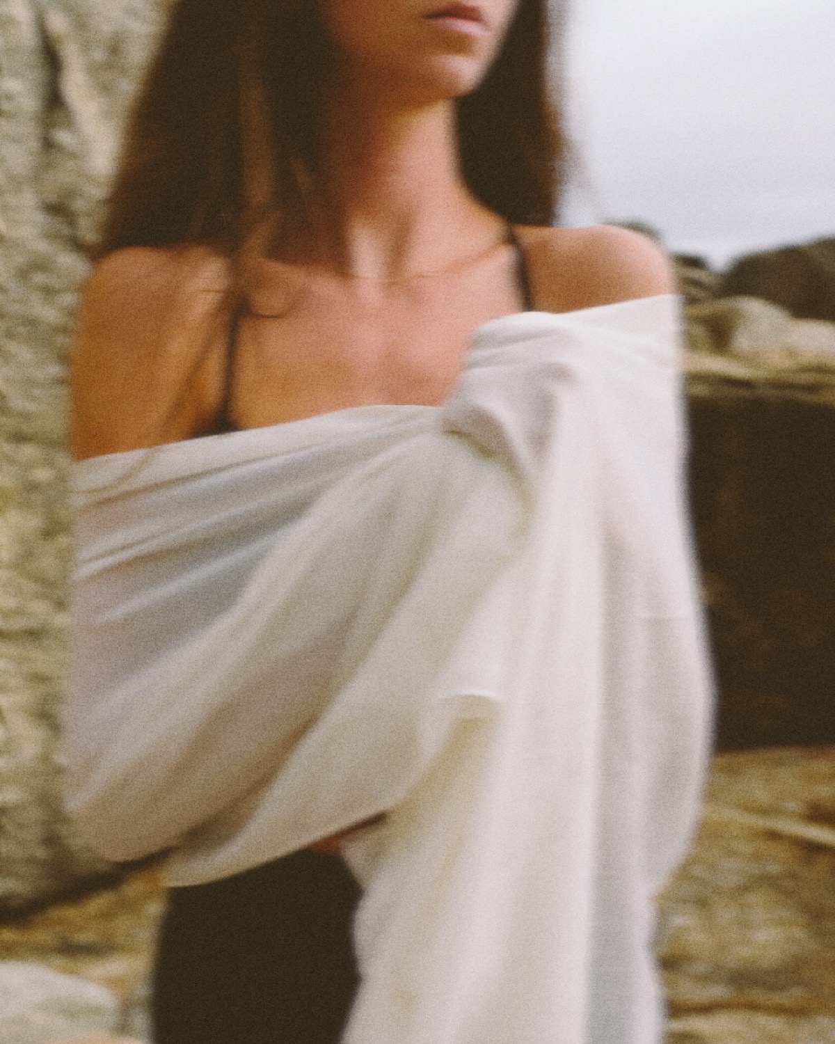 Linen wrapped over the shoulders in warm coastal light